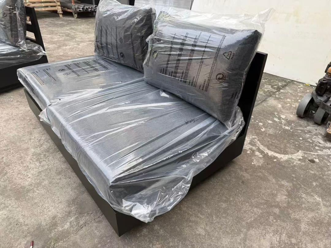 Custom black outdoor sectional sofa module wrapped for delivery