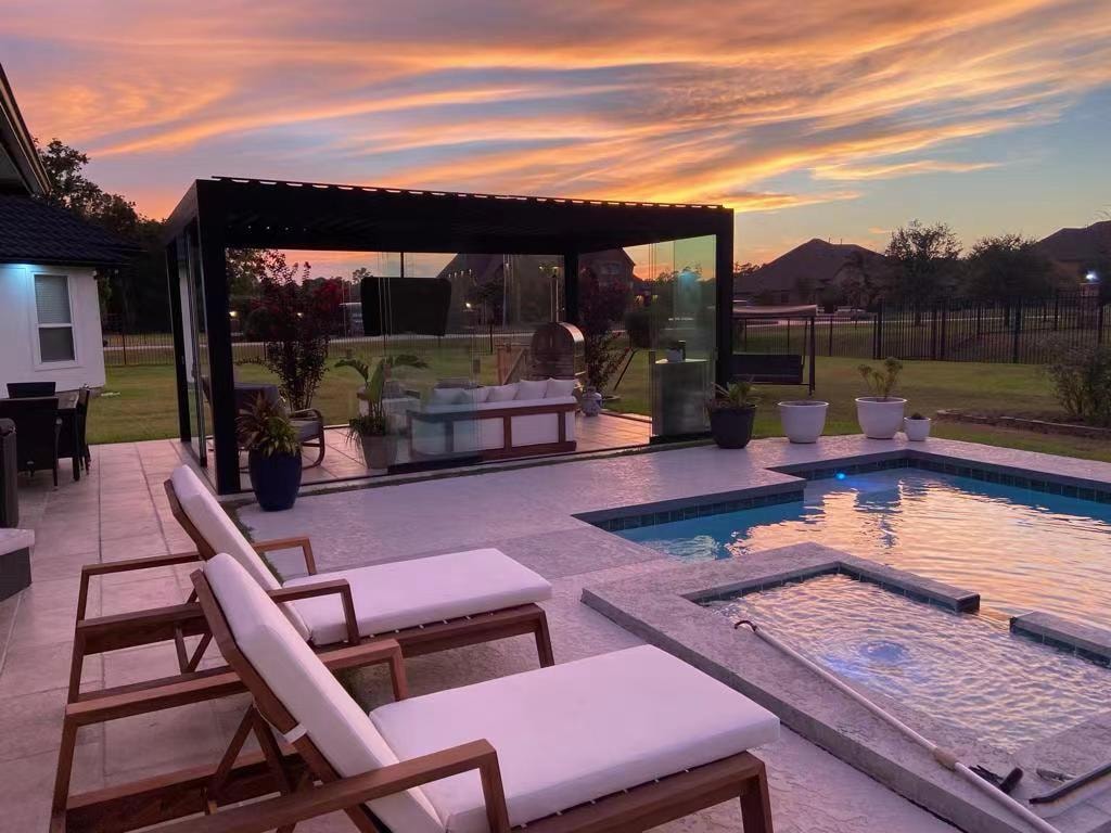 Outdoor living area at sunset with pool and lounge