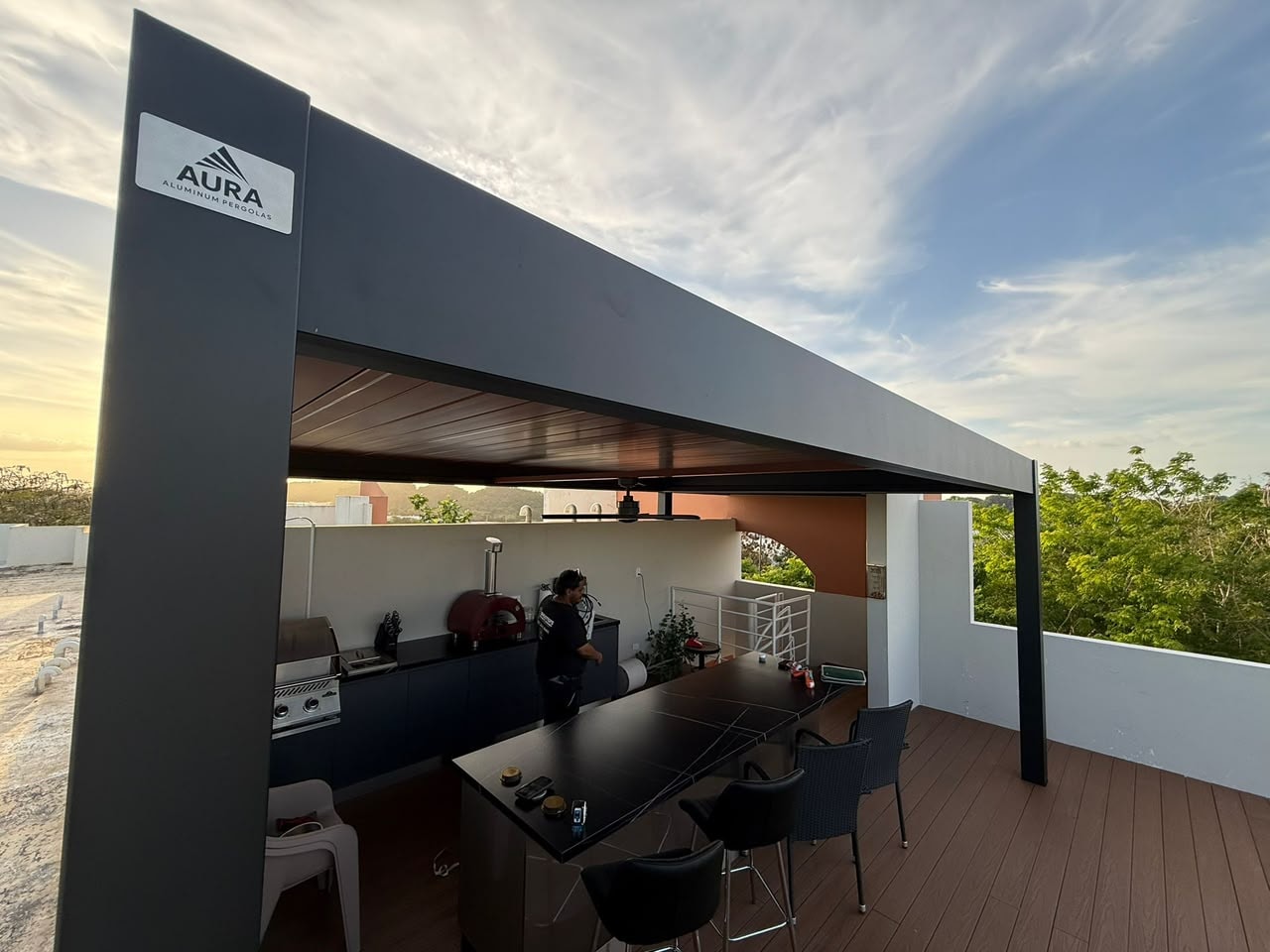 Aura aluminum pergola with outdoor kitchen at sunset
