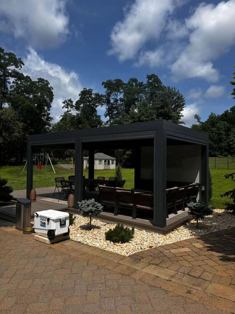 Black pergola with built-in seating and outdoor furniture
