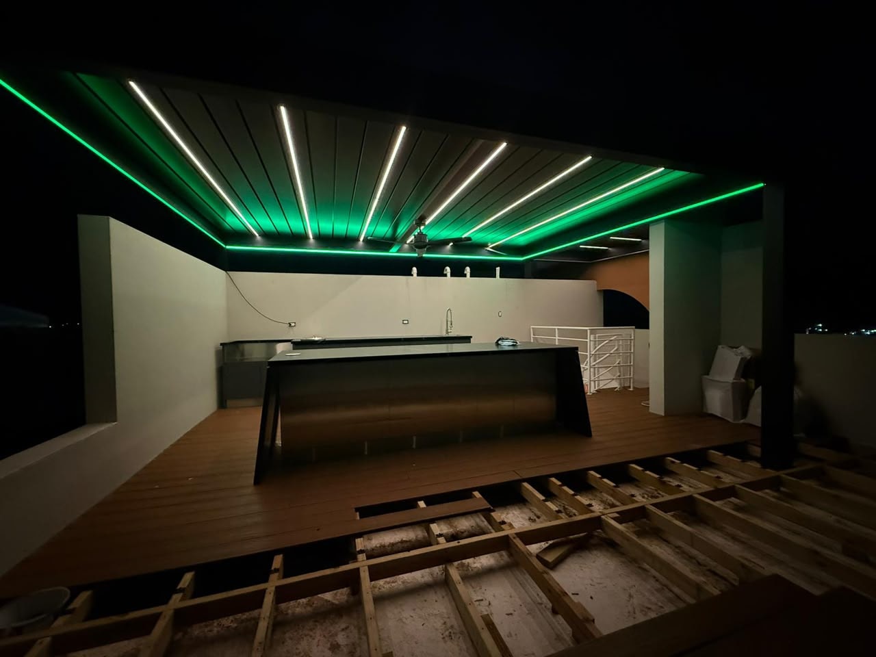 Pergola with green LED lighting at night